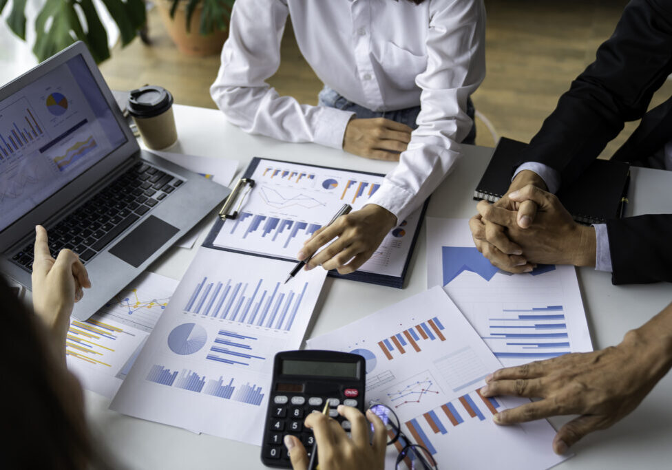 business people meeting in the office Calculate the tax and income of the company's investment. Strategic Planning and Brainstorming colleague concept, report, analyze graph plans