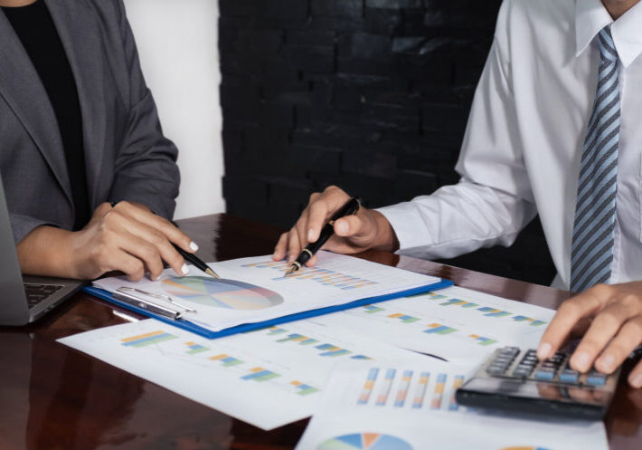 businessmen and businesswomen team meeting to plan strategies to increase business income. Have a brainstorming graph analysis and discussing for the new target success.